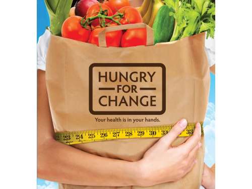 A brown paper bag full of vegetables with the slogan: “Hungry for change”