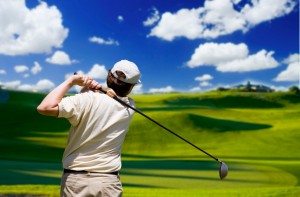 A man watching his golf ball soar off into the distance